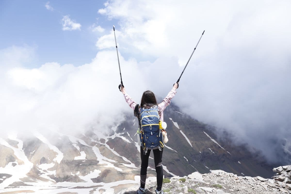 A hiker at a mountain summit