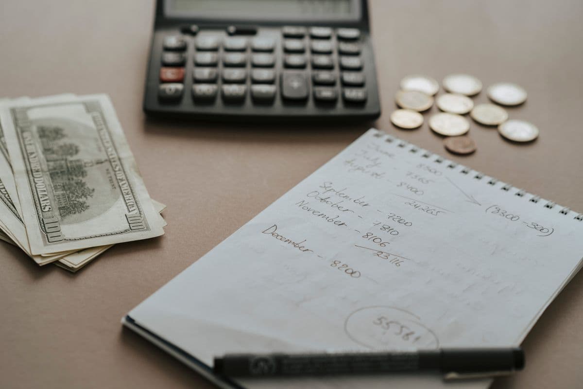 Budgeting with a calculator and coins